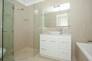 brand new bathroom with frameless neo angle shower doors